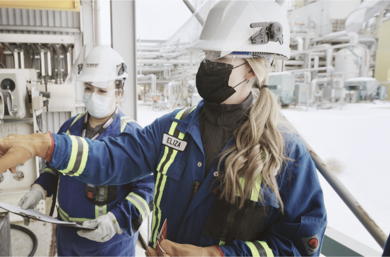 two women engineers in full PPE working on a site